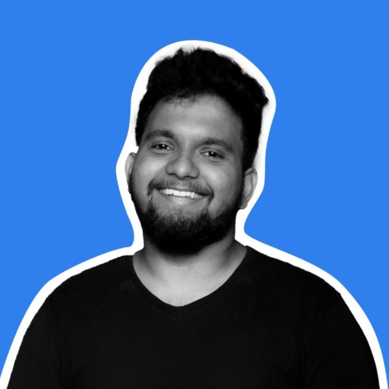 Naveen Kumar smiling in a black shirt